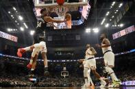 Milwaukee Bucks' Giannis Antetokounmpo is foukled by New York Knicks' Mitchell Robinson as he shoots during the first half of an NBA basketball game Friday, Jan. 28, 2022, in Milwaukee. (AP Photo/Morry Gash)