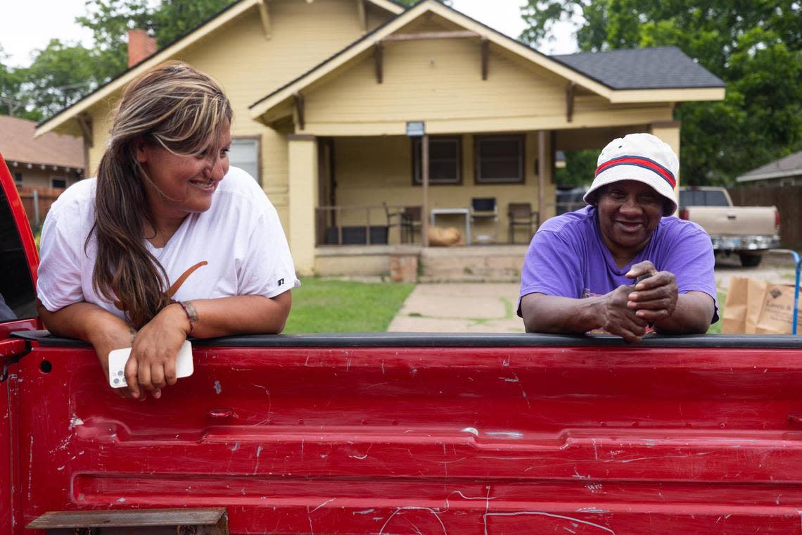 Sandra Quintana and Jeanette Powell chat near a truck on May 23, 2022, in the neighborhood where Atatiana Jefferson was killed in Fort Worth.