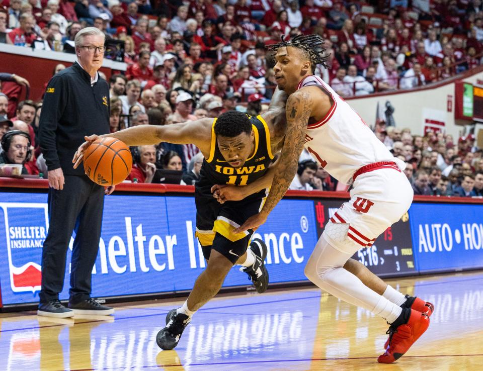 Feb 28, 2023; Bloomington, Indiana, USA; Iowa Hawkeyes guard Tony Perkins (11) dribbles the ball while Indiana Hoosiers guard CJ Gunn (11) defends in the second half at Simon Skjodt Assembly Hall.