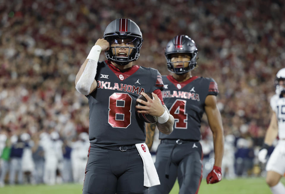 Oklahoma quarterback Dillon Gabriel (8) celebrates after a touchdown against West Virginia during the first half of an NCAA college football game Saturday, Nov. 11, 2023, in Norman, Okla. (AP Photo/Alonzo Adams)