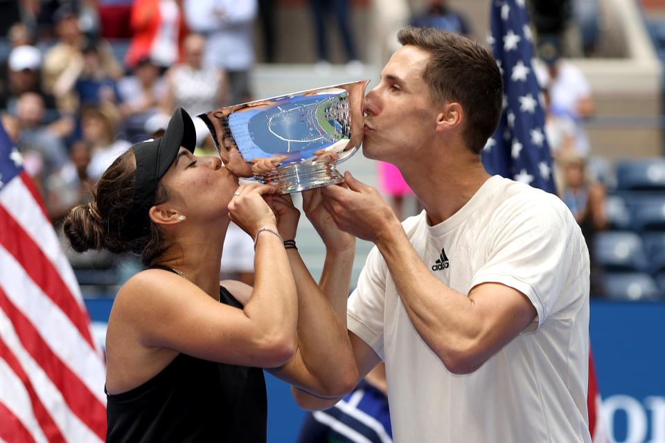 Desirae Krawczyk and Joe Salisbury celebrate with the championship trophy after defeating Giuliana Olmos of Mexico and Marcelo Arevalo of El Salvador in their mixed doubles final at the USTA Billie Jean King National Tennis Center on September 11, 2021