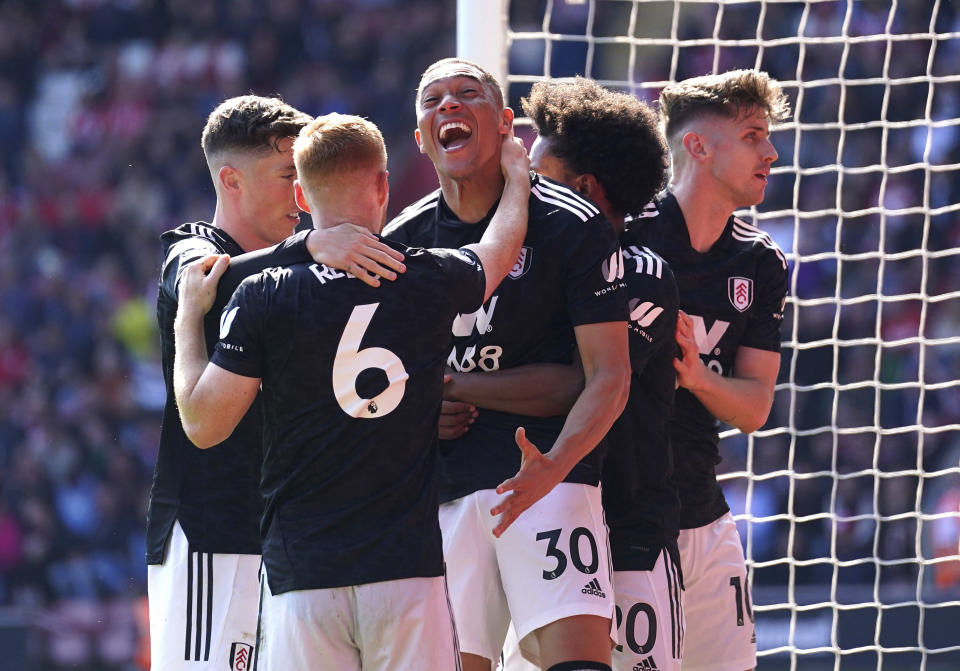 Fulham's Carlos Vinicius, centre, celebrates with teammates after scoring to 0-1 during the Premier League soccer match between Southampton FC and Fulham FC at St. Mary's Stadium, in Southampton, England, Saturday May 13, 2023. (Adam Davy/PA via AP)