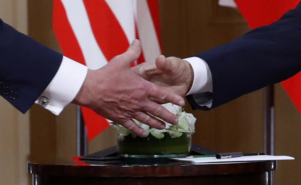 U.S. President Donald Trump, left, and Russian President Vladimir Putin shake hand at the beginning of a meeting at the Presidential Palace in Helsinki, Finland, Monday, July 16, 2018. (AP Photo/Pablo Martinez Monsivais)