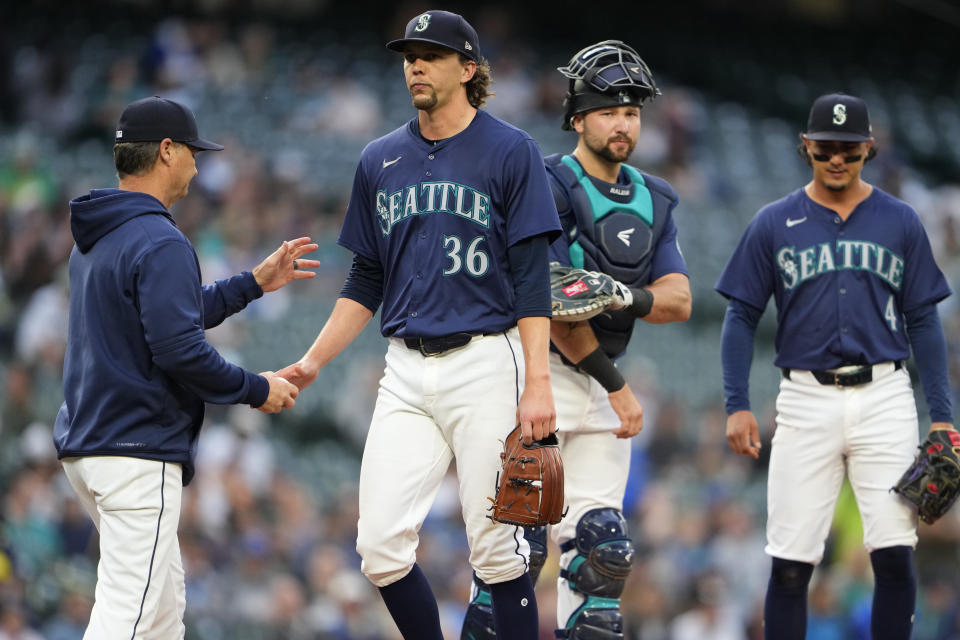 Seattle Mariners starting pitcher Logan Gilbert is taken out of the game against the Chicago White Sox by manager Scott Servais as catcher Cal Raleigh and third baseman Josh Rojas (4) look on during the seventh inning of a baseball game Monday, June 10, 2024, in Seattle. (AP Photo/Lindsey Wasson)