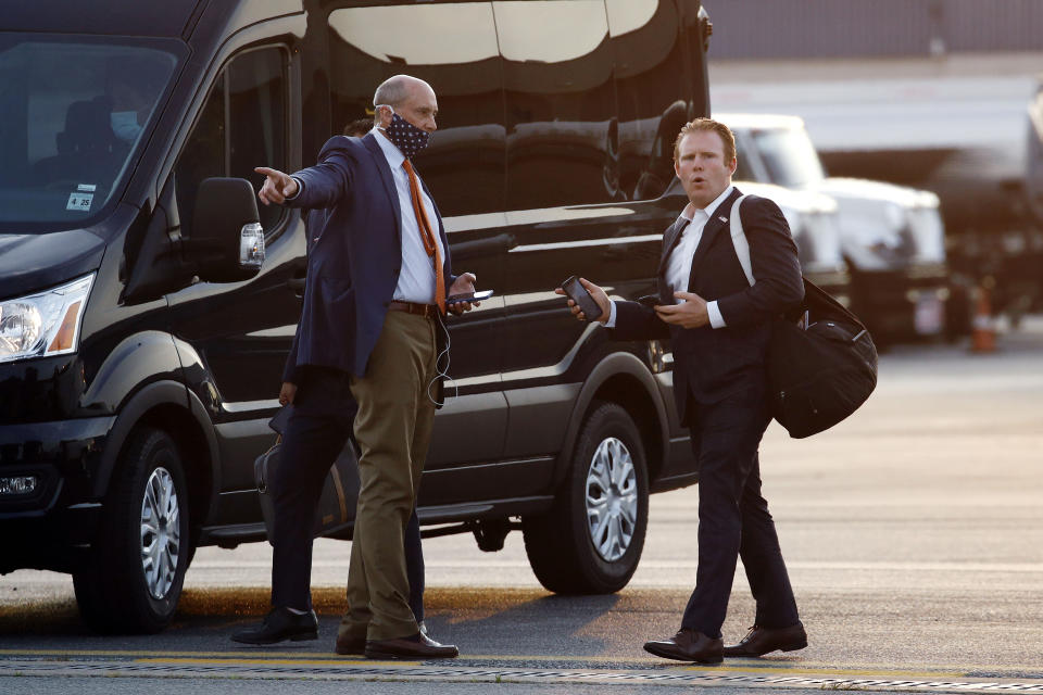 FILE - Andrew Giuliani, right, Special Assistant to President Donald Trump, walks to a van after stepping off Air Force One at Morristown Municipal Airport in Morristown, N.J., July 24, 2020. One place the former New York City mayor is in high demand these days is on the campaign of his son, Andrew Giuliani, who on Tuesday is hoping to become the Republican nominee for governor of New York. (AP Photo/Patrick Semansky, File)