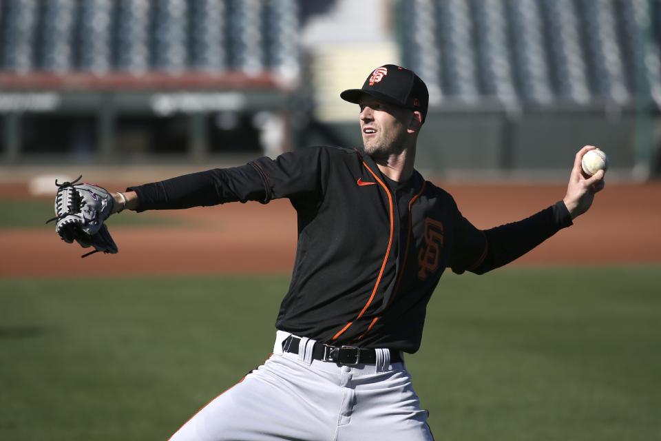 San Francisco Giants pitcher Drew Smyly warms up during spring training baseball workouts for pitchers and catchers Wednesday, Feb. 12, 2020, in Scottsdale, Ariz. (AP Photo/Ross D. Franklin)