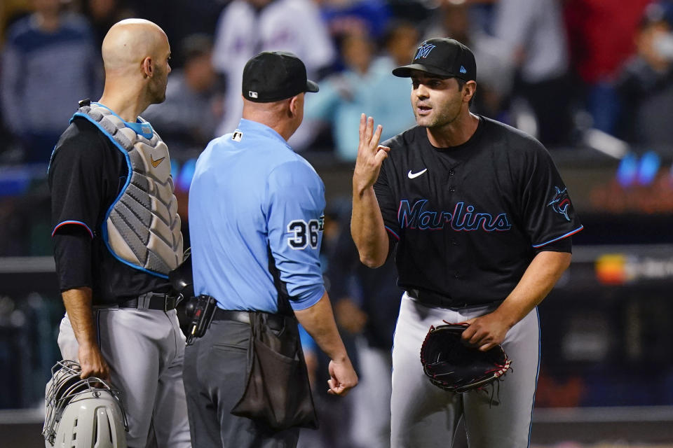 Miami Marlins relief pitcher Richard Bleier, right, argues with home plate umpire Ryan Blakney, center, after being ejected after the eighth inning of the team's baseball game against the New York Mets on Tuesday, Sept. 27, 2022, in New York. The Marlins won 6-4. (AP Photo/Frank Franklin II)