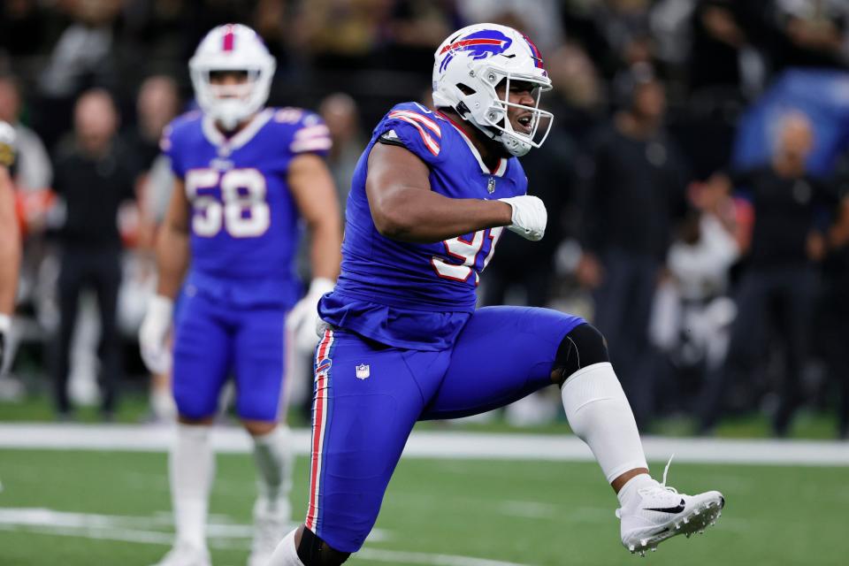 Bills defensive tackle Ed Oliver celebrates his sack in the first half.