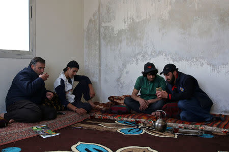 Parkour coach Ibrahim al-Kadiri, 19, drinks tea with his friends in the rebel-held city of Inkhil, west of Deraa, Syria, April 7, 2017. REUTERS/Alaa Al-Faqir