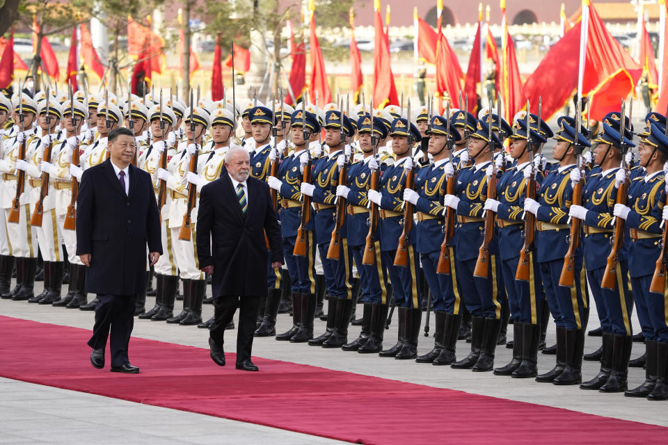 Brazilian President Luiz Inacio Lula da Silva, right, inspects an honor guard with Chinese President Xi Jinping during a welcome ceremony held outside the Great Hall of the People in Beijing, China, Friday, April 14, 2023. (Ken Ishii/Pool Photo via AP)