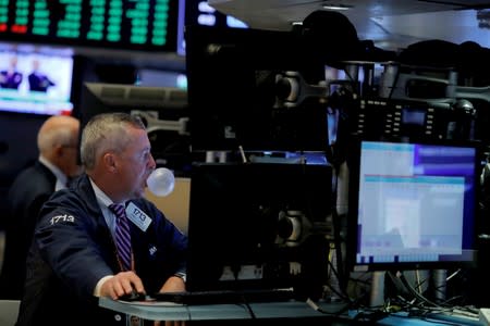 A trader works on the trading floor at the New York Stock Exchange (NYSE) at the opening of the market in New York City