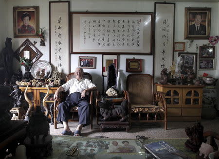 Huang Chin-chi, 92, poses for a photograph in his living room in Kinmen county, Taiwan, September 7, 2015. REUTERS/Pichi Chuang