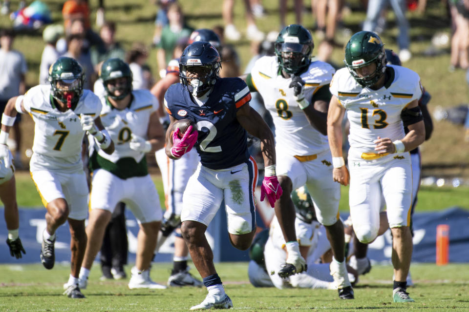 Virginia running back Perris Jones (2) breaks away for a big gain against the William & Mary defense during the second half of an NCAA college football game Saturday, Oct. 7, 2023, in Charlottesville, Va. (AP Photo/Mike Caudill)