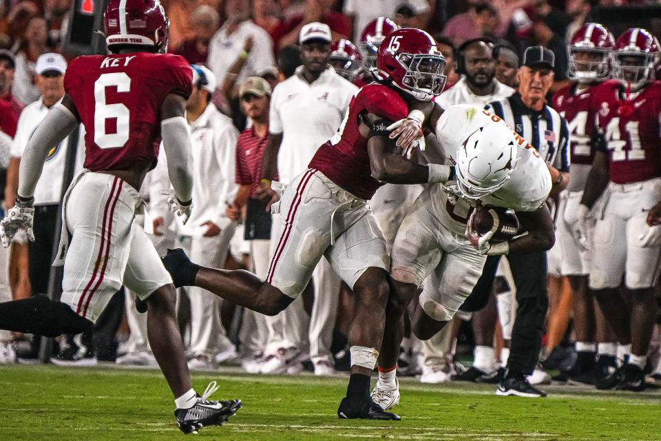 Texas tight end Ja'Tavion Sanders is tackled by Alabama linebacker Dallas Turner during the Longhorns' 34-24 win at Bryant-Denny Stadium. Sanders had a career game with 114 yards receiving.