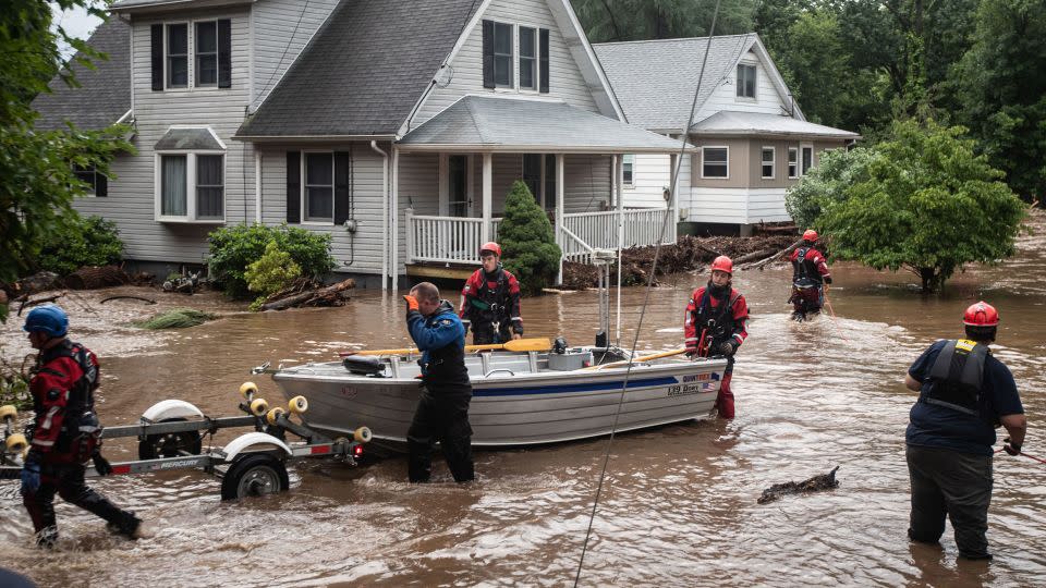 Emergency personnel used a boat to rescue residents of flooded homes on Lowland Hill Road in Stony Point, New York,  on Sunday. - Seth Harrison/The Journal News/USA Today Network