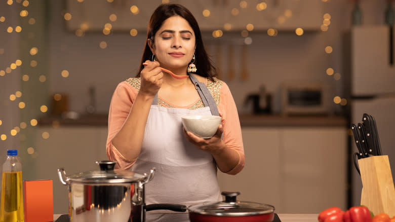 Indian woman tasting food