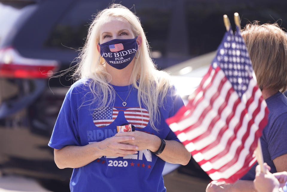 A supporter of Democratic presidential candidate former Vice President Joe Biden gathers with others for a Ridin' With Biden event Sunday, Oct. 11, 2020, in Plano, Texas. Democrats in Texas are pressing Joe Biden to make a harder run at Texas with less than three weeks until Election Day. (AP Photo/LM Otero)