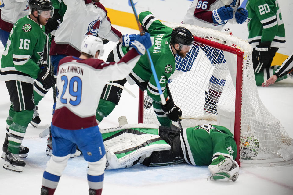 Dallas Stars goaltender Scott Wedgewood, bottom right, lies on the ice after allowing a goal to Colorado Avalanche right wing Mikko Rantanen, not visible, during the third period of an NHL hockey game, Thursday, Jan. 4, 2024 in Dallas. The Avalanche won 5-4 in overtime. (AP Photo/Julio Cortez)