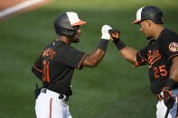 Baltimore Orioles' Cedric Mullins (31) celebrates his home run with Anthony Santander (25) during the first inning of the first baseball game of a doubleheader against the New York Yankees, Friday, Sept. 4, 2020, in Baltimore. (AP Photo/Nick Wass)