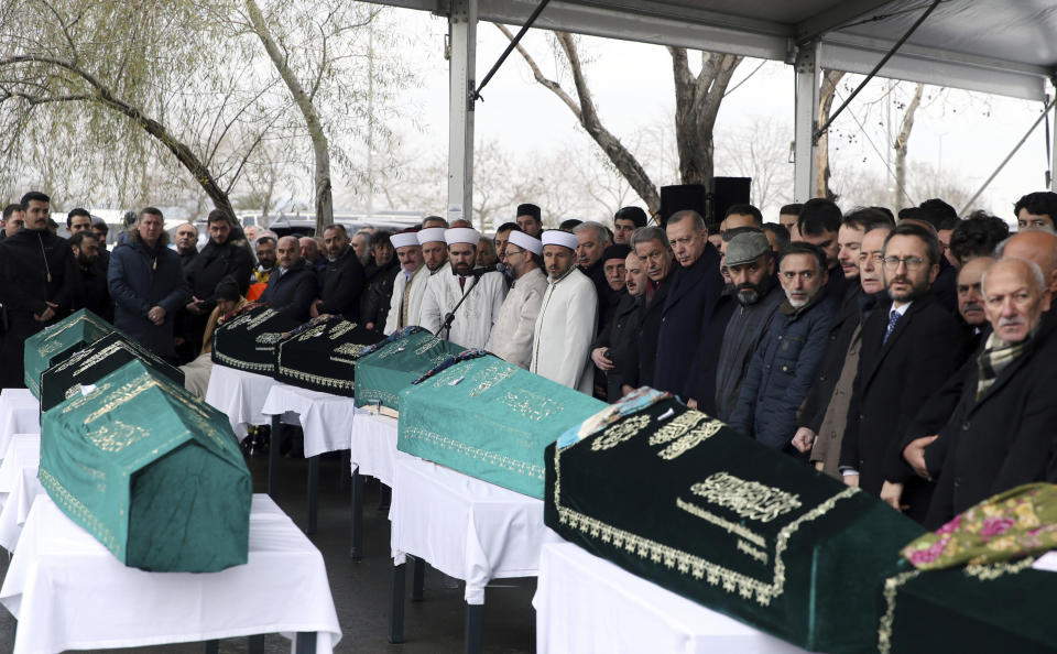 Turkey's President Recep Tayyip Erdogan, center, joins hundreds of mourners who attend the funeral prayers for nine members of Alemdar family killed in a collapsed apartment building, in Istanbul, Saturday, Feb. 9, 2019. Erdogan says there are "many lessons to learn" from the collapse of a residential building in Istanbul where at least 17 people have died.(Presidential Press Service via AP, Pool)