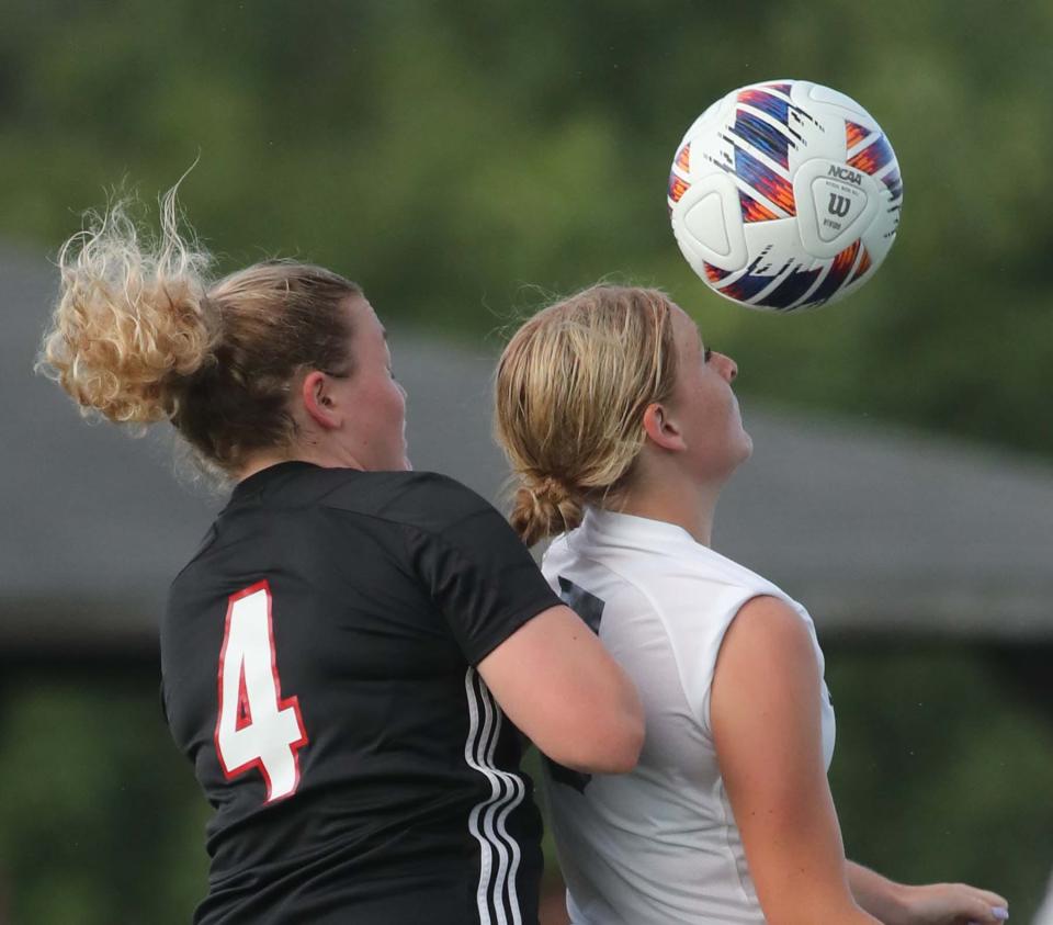 Grace Soles, left, of Manchester and Natalie Shimmel of Hoban during the first half of their game at Manchester High School in New Franklin on Monday. 