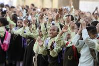 Students line up and raise their hands on the first day of their new school year at a government school in Giza, south of Cairo September 22, 2013. Students resumed their studies at the beginning of the new academic year this weekend amid parental concerns of a possible lack of security after the summer vacation ends. REUTERS/Mohamed Abd El Ghany (EGYPT - Tags: POLITICS EDUCATION)