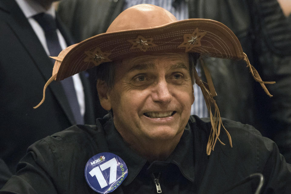 Presidential frontrunner Jair Bolsonaro, of the Social Liberal Party wears a traditional Brazilian cowboy hat during a press conference in Rio de Janeiro, Brazil, Thursday, Oct. 11, 2018. Bolsonaro will face Workers Party presidential candidate Fernando Haddad in a presidential runoff on Oct. 28. (AP Photo/Leo Correa)