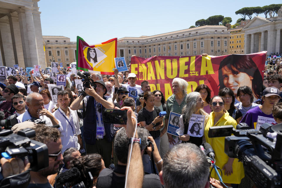 People hold pictures of missing girl Emanuela Orlandi during a sit-in in St.Peter's Square as Pope Francis recites the Angelus noon prayer, at the Vatican, Sunday, June 25, 2023. The Pope in his speech remembered the 40th anniversary of the disappearance of Emanuela Orlandi, the 15-year-old daughter of a lay employee of the Holy See, that vanished June 22, 1983, after leaving her family's Vatican City apartment to go to a music lesson in Rome. (AP Photo/Andrew Medichini)