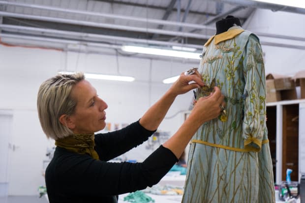 Michele Clapton tends to Mary's dress.