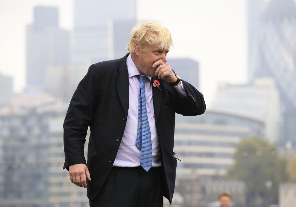 Mayor of London Boris Johnson recovers after taking part in a tug of war with personnel from the Royal Navy, the Army and the Royal Air Force at the launch of London Poppy Day, on Potters Field, next to City Hall in London.