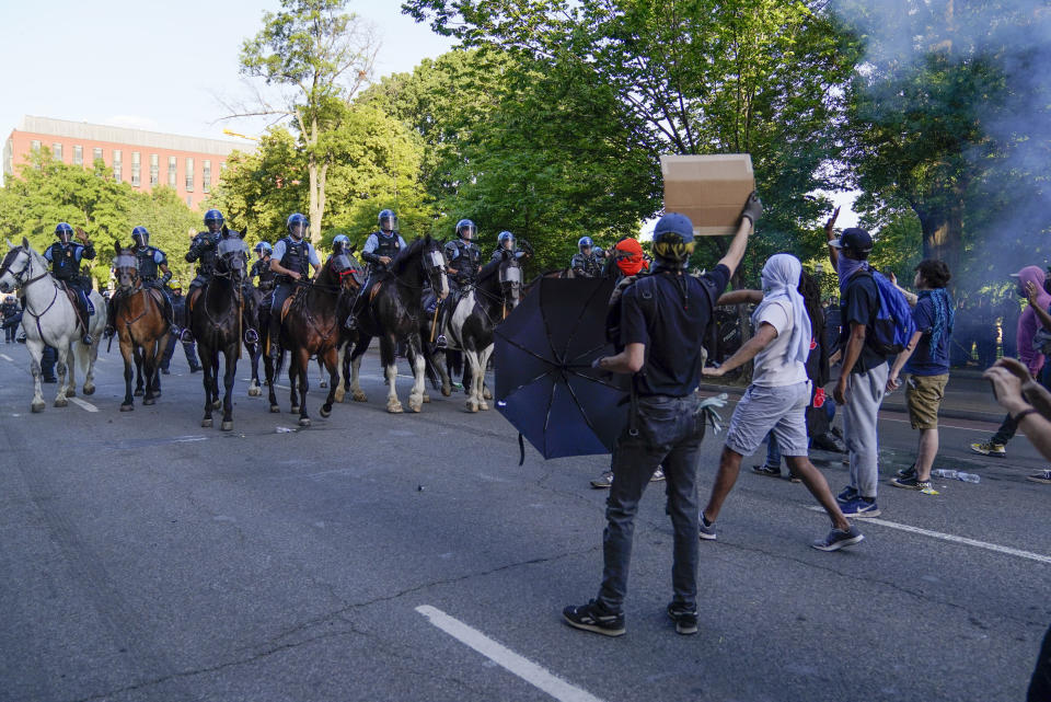 Police on horseback begin to approach demonstrators who had gathered to protest the death of George Floyd, Monday, June 1, 2020, near the White House in Washington. Floyd died after being restrained by Minneapolis police officers. (AP Photo/Evan Vucci)