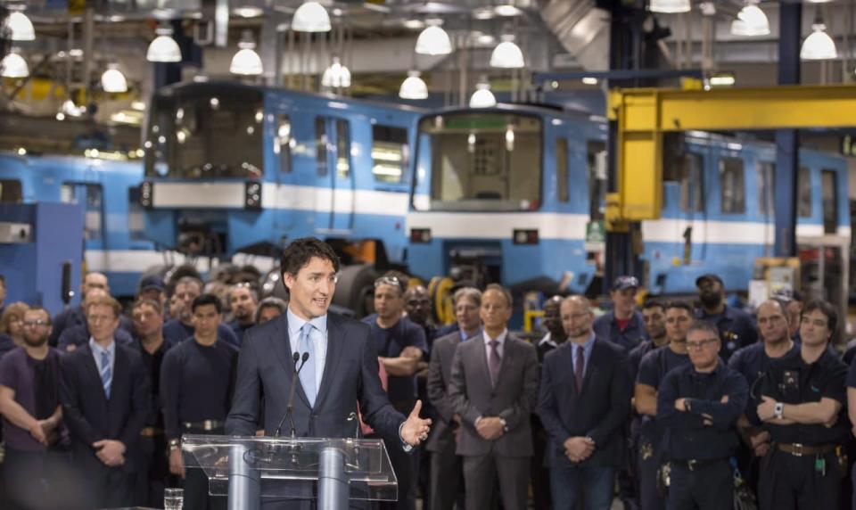 Prime Minister Justin Trudeau addresses the workers and media as he tours a garage of the Montreal Transportation Commission, Wednesday, April 6, 2016 in Montreal. THE CANADIAN PRESS/Paul Chiasson