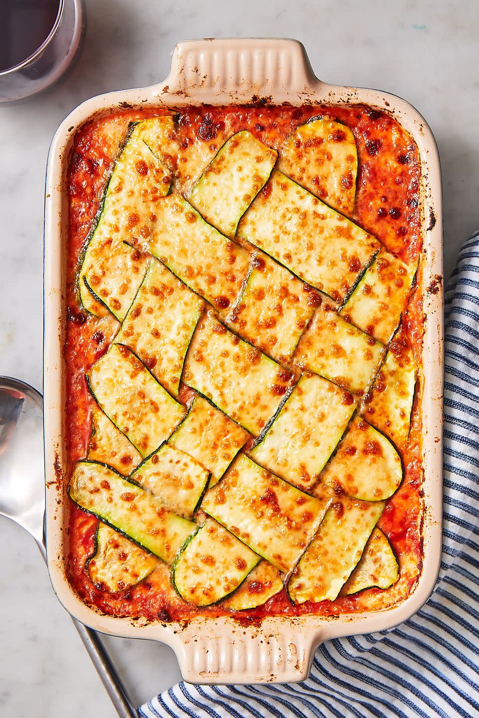 <p>Yes, <a href="https://www.delish.com/cooking/recipe-ideas/recipes/a51337/classic-lasagna-recipe/" rel="nofollow noopener" target="_blank" data-ylk="slk:classic lasagna;elm:context_link;itc:0;sec:content-canvas" class="link ">classic lasagna</a> is delicious, but when we're craving something a tad less carb-heavy, we turn to this summery zucchini version. Pro tip: Zucchini releases a good amount of water, so we like to dab it with a paper towel when the lasagna is done cooking, and then broil until the cheese is bubbly and crispy. 😍</p><p>Get the <strong><a href="https://www.delish.com/cooking/recipe-ideas/recipes/a48657/zucchini-lattice-lasagna-recipe/" rel="nofollow noopener" target="_blank" data-ylk="slk:Zucchini Lattice Lasagna recipe;elm:context_link;itc:0;sec:content-canvas" class="link ">Zucchini Lattice Lasagna recipe</a></strong>.</p>