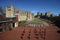 <p>The Foot Guards Band stand in formation outside St George’s Chapel at Windsor Castle. </p>