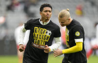 FILE - Dortmund's Jude Bellingham, left, and Erling Haaland wear t-shirts bearing an anti-racism message prior to the German Bundesliga soccer match between Borussia Dortmund and FSV Mainz 05 in Dortmund, Germany, Saturday, Oct. 16, 2021. The manifestation of a deeper societal problem, racism is a decades-old issue in soccer — predominantly in Europe but seen all around the world — that has been amplified by the reach of social media and a growing willingness for people to call it out. (AP Photo/Martin Meissner, File)