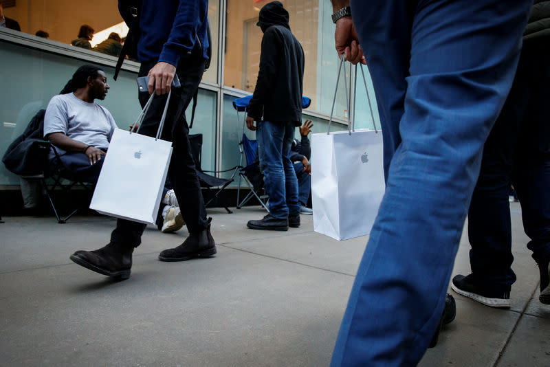 Customers wait in line for the new iPhone X outside an Apple store in New York City