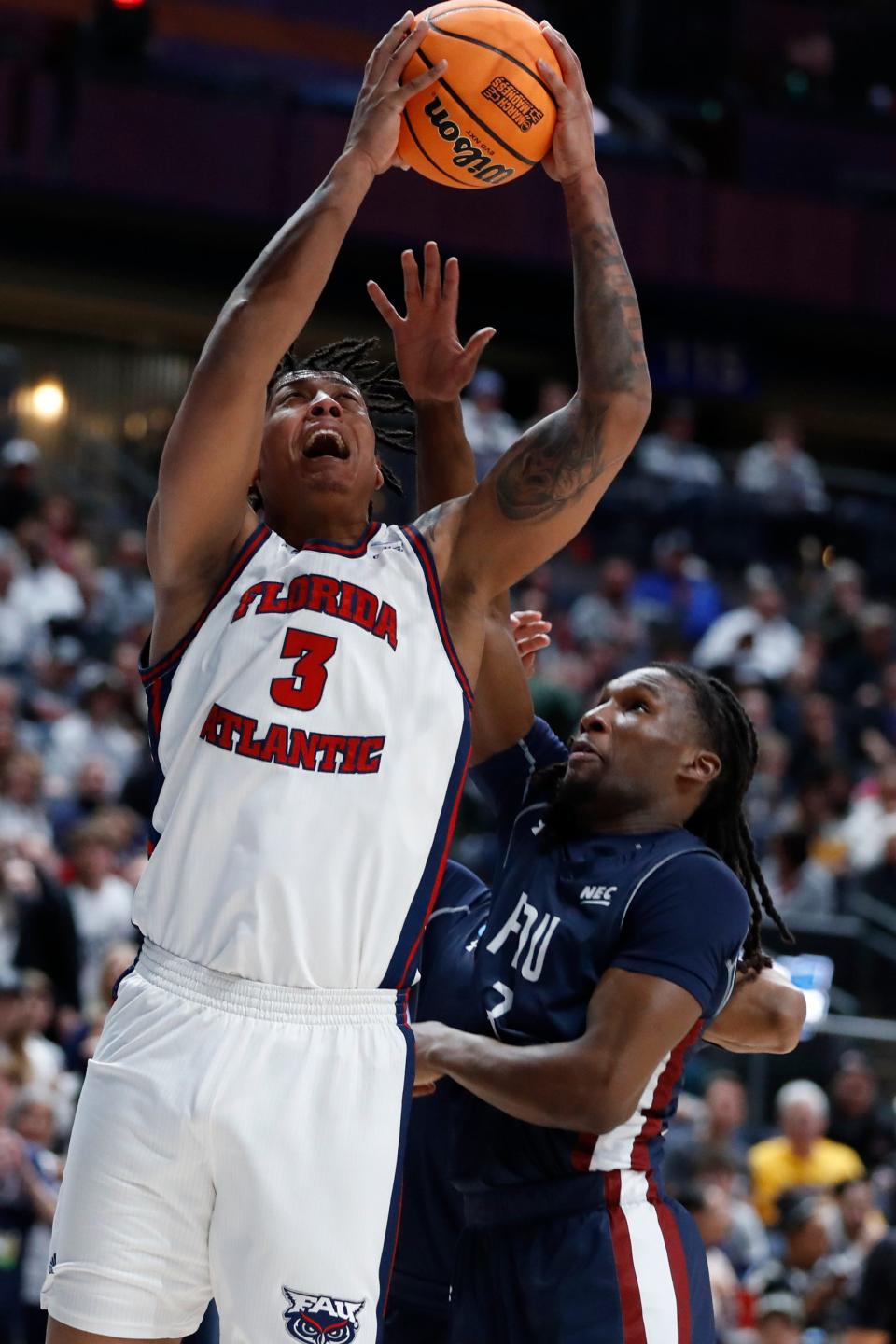 Mar 19, 2023; Columbus, OH, USA; Florida Atlantic Owls forward Giancarlo Rosado (3) jumps for the basket defended by Fairleigh Dickinson Knights guard Heru Bligen (3) in the first half at Nationwide Arena. Mandatory Credit: Joseph Maiorana-USA TODAY Sports