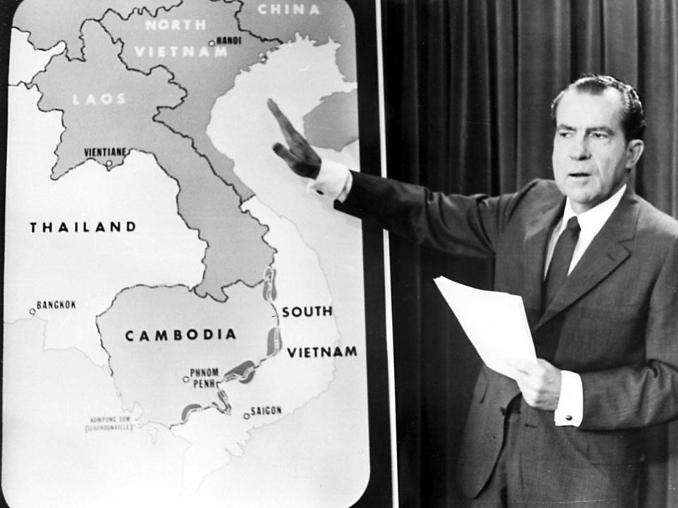 President Richard Nixon pointing to a map of Vietnam and Laos.