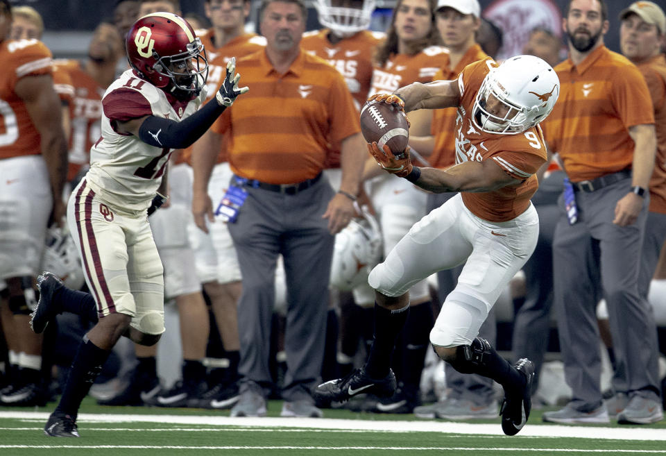 Texas wide receiver Collin Johnson (9) catches a pass in front of Oklahoma cornerback Parnell Motley (11) during the Big 12 Conference championship NCAA college football game in Arlington, Texas, on Saturday, Dec. 1, 2018. (Nick Wagner/Austin American-Statesman via AP)