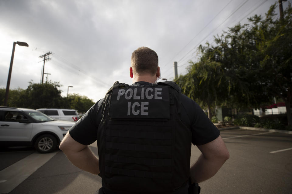 FILE - In this July 8, 2019, file photo, a U.S. Immigration and Customs Enforcement (ICE) officer looks on during an operation in Escondido, Calif. A federal judge has prohibited U.S. immigration authorities from relying on databases deemed faulty to ask law enforcement agencies to hold people in custody, a setback for the Trump administration that threatens to hamper how it carries out arrests (AP Photo/Gregory Bull, File)