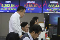 Currency traders watch monitors at the foreign exchange dealing room of the KEB Hana Bank headquarters in Seoul, South Korea, Thursday, Jan. 23, 2020. Asian shares are mostly higher as health authorities around the world move to monitor and contain a deadly virus outbreak in China and keep it from spreading globally. (AP Photo/Ahn Young-joon)