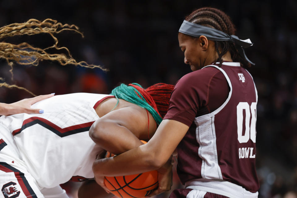 Texas A&M guard Sydney Bowles, right, forces a jump ball against South Carolina forward Aliyah Boston during the first half of an NCAA college basketball game in Columbia, S.C., Thursday, Dec. 29, 2022. (AP Photo/Nell Redmond)