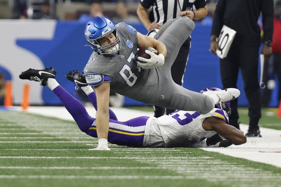 Detroit Lions rookie tight end Sam LaPorta is tackled by the Minnesota Vikings' Andrew Booth Jr. during the first quarter at Ford Field on Jan. 7, 2024 in Detroit.