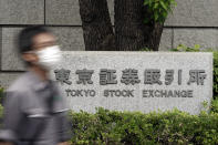 A man walks by the Tokyo Stock Exchange building Thursday, Oct. 1, 2020, in Tokyo. Trading on the Tokyo Stock Exchange was suspended Thursday because of a problem in the system for relaying market information. (AP Photo/Eugene Hoshiko)