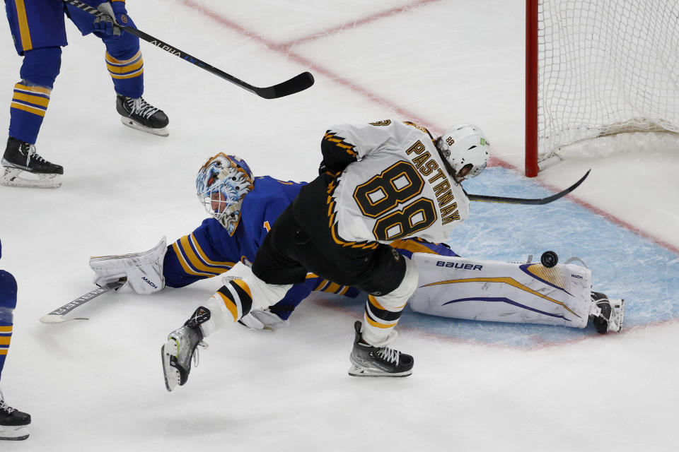 Buffalo Sabres goaltender Ukko-Pekka Luukkonen (1) makes a pad save on a shot by Boston Bruins right wing David Pastrnak (88) during the third period of an NHL hockey game, Saturday, Dec. 31, 2022, in Boston. (AP Photo/Mary Schwalm)