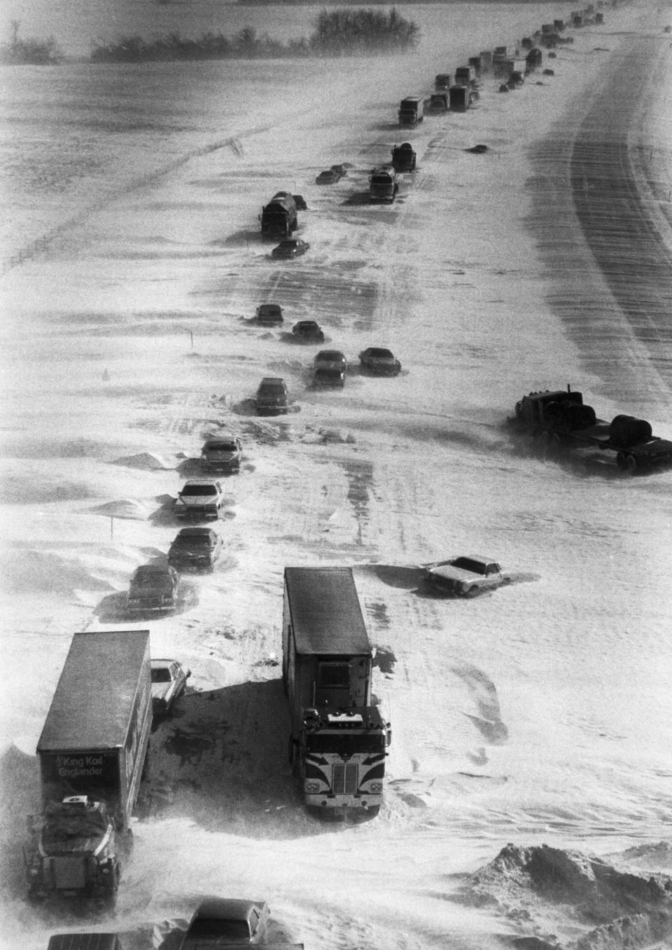1/29/1977-Lafayette, IN- As far as the eye can see, abandoned vehicles line snowbound I-65 near Lafayette in Central Indiana. Hundreds of truckers and motorists hav taken refuge in nearby towns waiting a break in the bitter sub-zero cold to resume their travels.