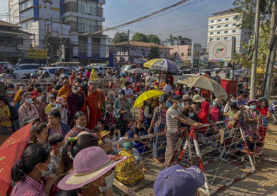 People gather outside Insein prison expecting to see prisoners being released in Yangon, Myanmar Friday, Feb. 12, 2021. Myanmar's military government expected to release thousands of prisoners to mark the anniversary of Myanmar's Union Day. (AP Photo)