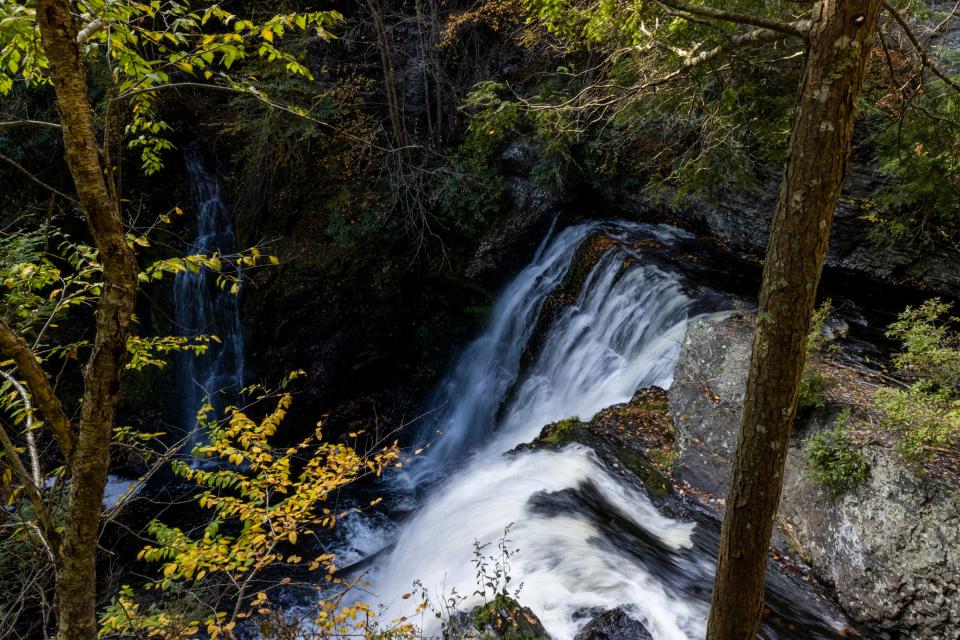 A view of the Raymondskill Falls at the Delaware Water Gap in Milford, Pa., on Friday, Oct. 15, 2021. Up a winding mountain road two hours from any major city, cars from Pennsylvania, New Jersey, and New York wedge into parking spots to see Raymondskill Falls, Pennsylvania’s tallest and one of the main attractions in the Delaware Water Gap National Recreation Area. (Tyger Williams/The Philadelphia Inquirer via AP)