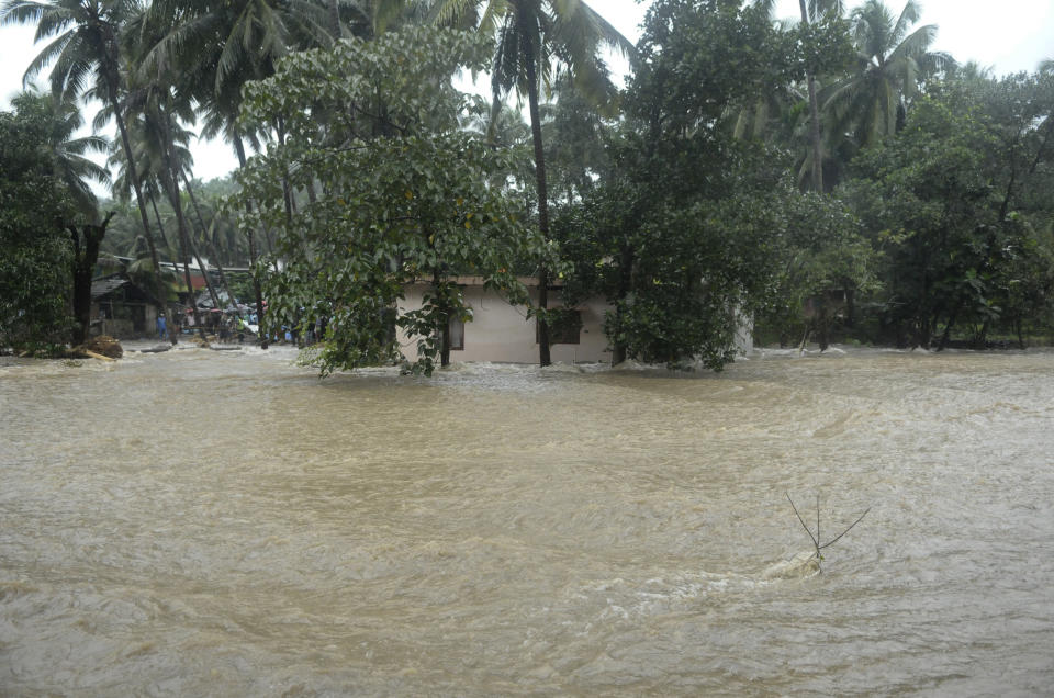 Roads and houses are engulfed in water following heavy rain and landslide in Kozhikode, Kerala state, India, Thursday, Aug. 9, 2018. Landslides triggered by heavy monsoon rains have killed more than a dozen people in southern India, cutting off road links and submerging several villages. (AP Photo)