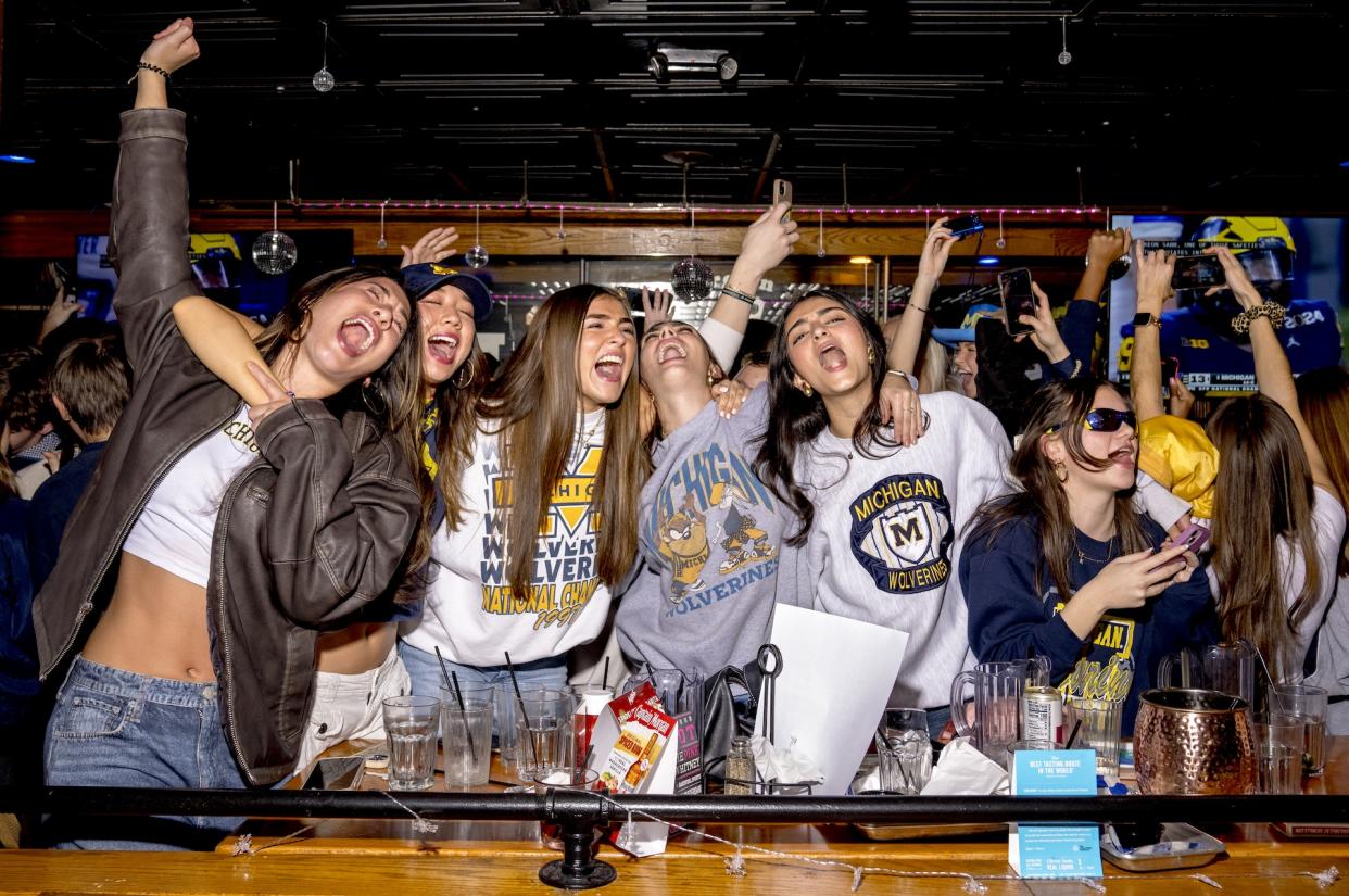 Michigan fans celebrate at the Brown Jug Restaurant in Ann Arbor. (Nic Antaya/Getty Images)